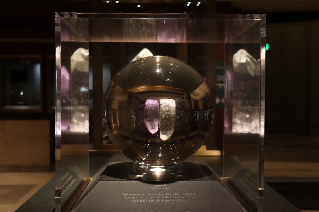 A large piece of clear quartz cut into the shape of a ball on display at the Smithsonian's National Museum of Natural History.